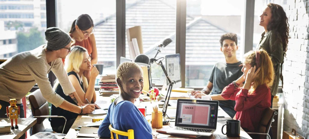 group of colleagues gathering around a table at work