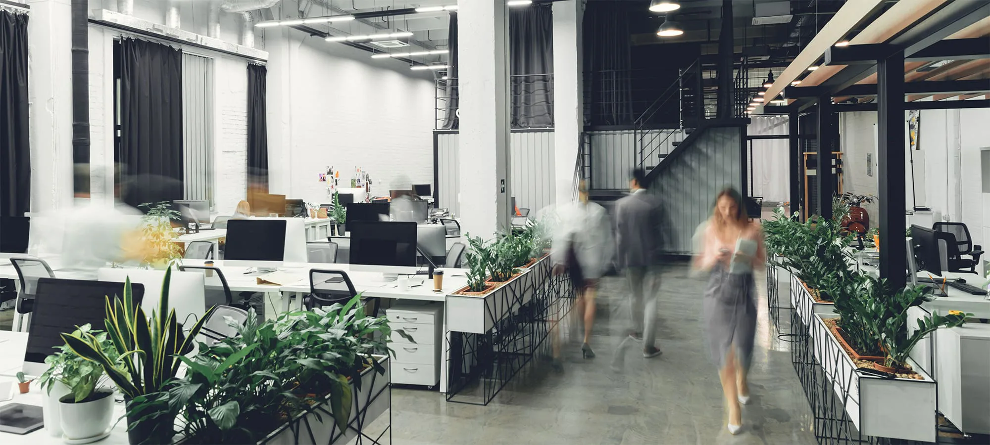 open plan office space with employees moving around