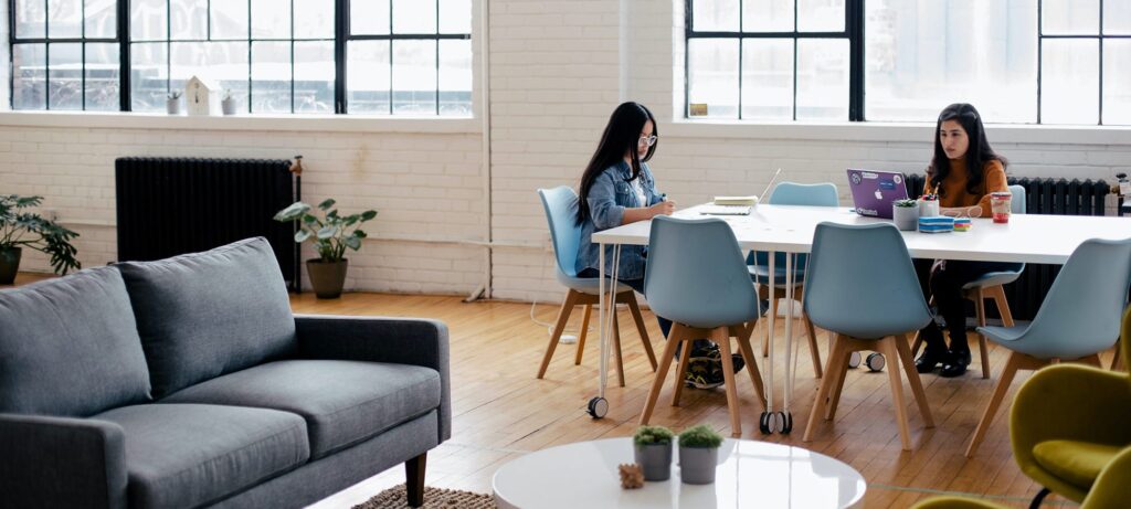 two women in the distance working at a table