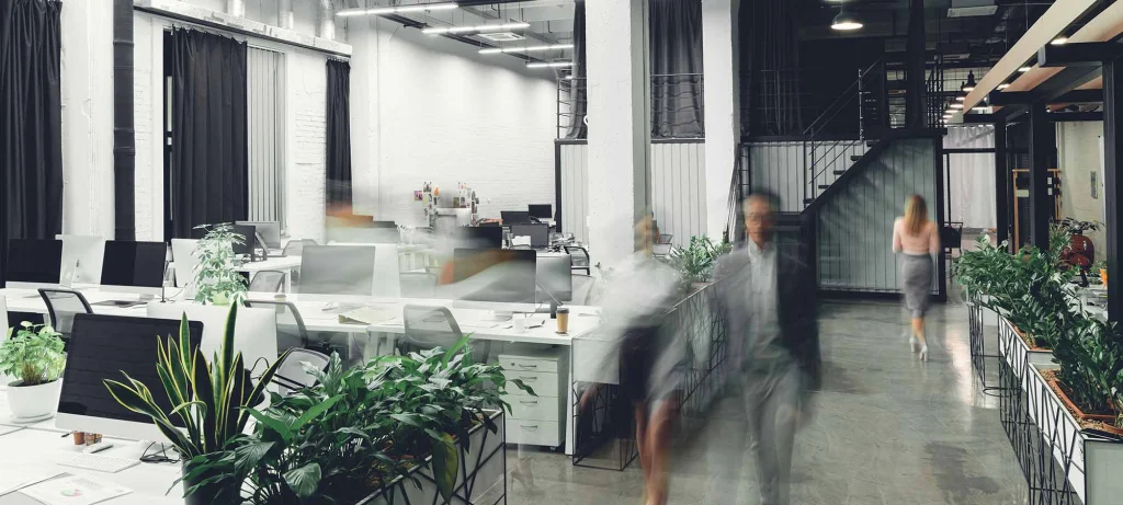 employees moving around an open office plan layout