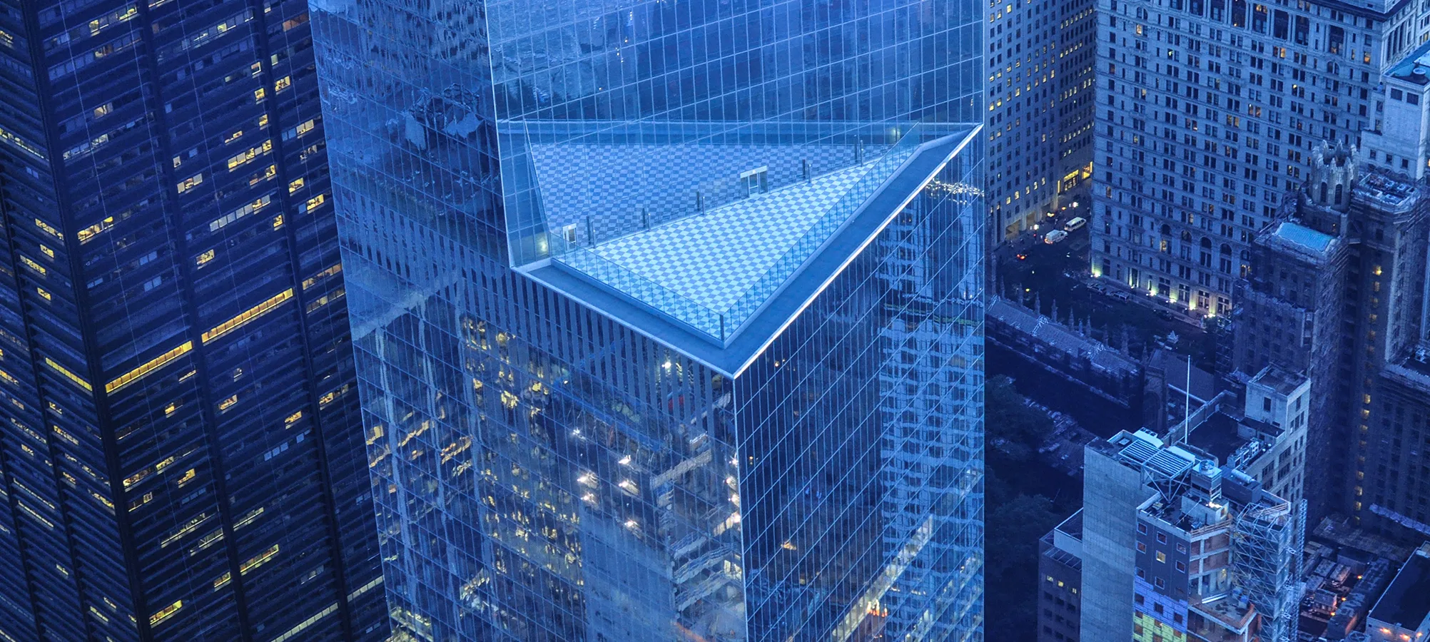 birds eye view of tall glass office buildings at night