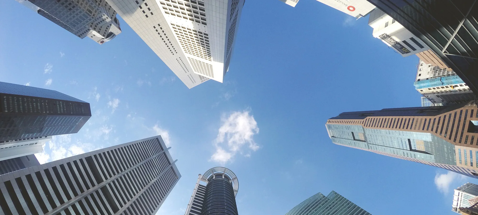 a worm's eye view of office buildings and the sky