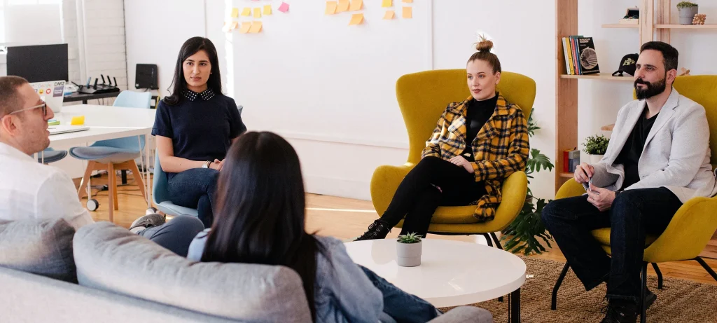 employees having a team meeting in an open office space