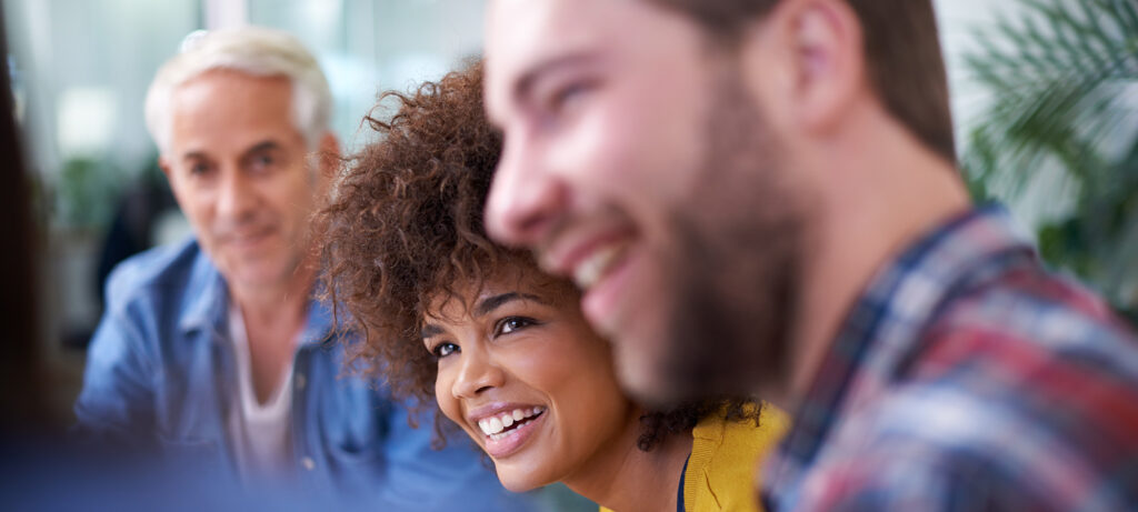 Shot of a group of happy coworkers in a meeting.